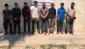 Polis yelekli, silahlı, telsizli ve kelepçeli göçmen kaçakçıları