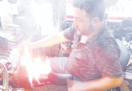 Ayakkabıları 45 derecede ateşle yakarak boyuyor